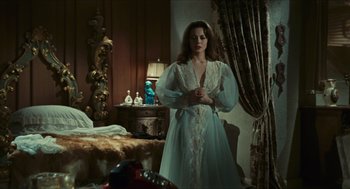 Movie still from “Black Sabbath” (1963), directed by Mario Bava – A woman in a white robe standing in front of a bed; Medium shot, High angle
