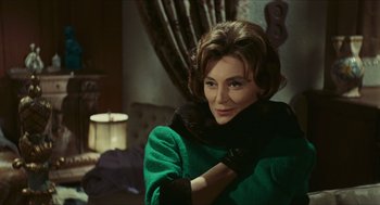 Movie still from “Black Sabbath” (1963), directed by Mario Bava – A woman wearing a green coat and black gloves; Close Up shot, Over the shoulder angle