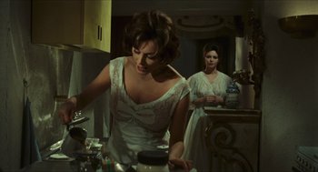 Movie still from “Black Sabbath” (1963), directed by Mario Bava – A woman in a white dress in front of another woman in a white dress; Medium shot, Over the shoulder angle