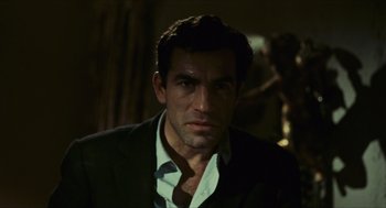 Movie still from “Black Sabbath” (1963), directed by Mario Bava – A person wearing a suit and tie; Close Up shot, Over the shoulder angle