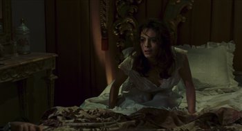 Movie still from “Black Sabbath” (1963), directed by Mario Bava – A woman in white dress laying on a bed; Medium shot, High angle