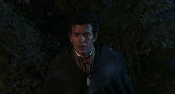 Movie still from “Black Sabbath” (1963), directed by Mario Bava – A man wearing a coat and a bow tie standing in front of a tree; Close Up shot, Over the shoulder angle