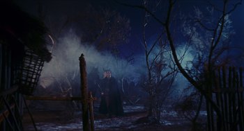 Movie still from “Black Sabbath” (1963), directed by Mario Bava – Two people in a dark forest at night with fog; Wide shot, High angle