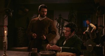 Movie still from “Black Sabbath” (1963), directed by Mario Bava – Two men sitting at a dinner table eating food; Medium shot, Over the shoulder angle