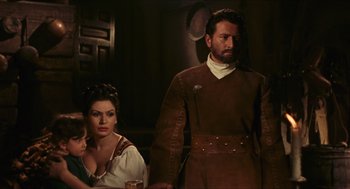 Movie still from “Black Sabbath” (1963), directed by Mario Bava – A man and a woman standing next to each other; Medium shot, Over the shoulder angle