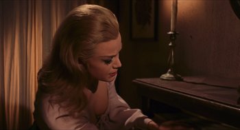 Movie still from “Black Sabbath” (1963), directed by Mario Bava – A woman sitting in front of a table with a candle; Close Up shot, High angle