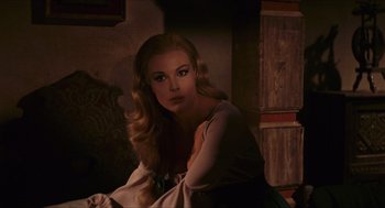 Movie still from “Black Sabbath” (1963), directed by Mario Bava – A woman sitting in a chair with her hand on her chin; Close Up shot, Over the shoulder angle