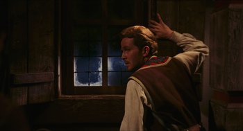 Movie still from “Black Sabbath” (1963), directed by Mario Bava – A man in a brown vest is standing in front of a window; Medium shot, Over the shoulder angle
