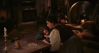 Movie still from “Black Sabbath” (1963), directed by Mario Bava – A woman and a child are sitting on a table; Medium shot, High angle