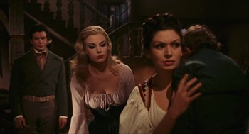 Movie still from “Black Sabbath” (1963), directed by Mario Bava – Two beautiful women standing next to each other in a room; Medium shot, Over the shoulder angle