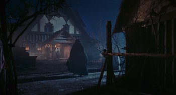 Movie still from “Black Sabbath” (1963), directed by Mario Bava – Two people are standing in front of a house at night; Wide shot, Low angle