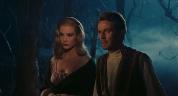 Movie still from “Black Sabbath” (1963), directed by Mario Bava – A man and a woman standing next to each other in front of trees; Medium shot, Low angle