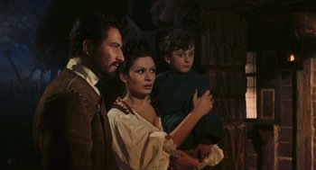 Movie still from “Black Sabbath” (1963), directed by Mario Bava – A man , woman , and a child standing next to each other; Medium shot, Over the shoulder angle