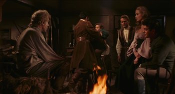 Movie still from “Black Sabbath” (1963), directed by Mario Bava – A group of people standing around a fire; Wide shot, Over the shoulder angle