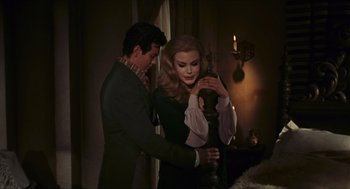 Movie still from “Black Sabbath” (1963), directed by Mario Bava – A man and a woman standing next to each other in front of a window; Medium shot, High angle