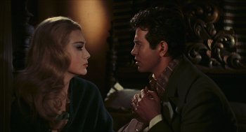 Movie still from “Black Sabbath” (1963), directed by Mario Bava – A man and a woman sitting next to each other in a room; Close Up shot, Over the shoulder angle