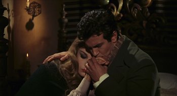 Movie still from “Black Sabbath” (1963), directed by Mario Bava – A man and a woman are kissing in a dark room; Medium shot, High angle