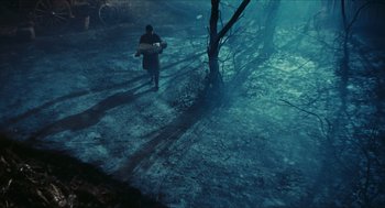 Movie still from “Black Sabbath” (1963), directed by Mario Bava – A man walking through a forest holding a bag; Extreme Wide shot, High angle