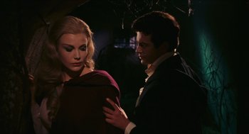 Movie still from “Black Sabbath” (1963), directed by Mario Bava – A man and a woman standing next to each other in the dark; Medium shot, Over the shoulder angle