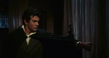 Movie still from “Black Sabbath” (1963), directed by Mario Bava – A man in a suit and tie holding onto a curtain; Medium shot, Over the shoulder angle