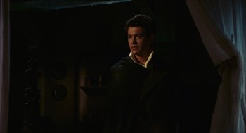 Movie still from “Black Sabbath” (1963), directed by Mario Bava – A man standing in the dark in a room; Medium shot, Over the shoulder angle