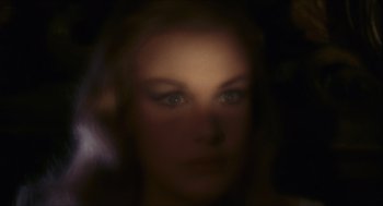 Movie still from “Black Sabbath” (1963), directed by Mario Bava – A woman's face is blurry in a dark room; Close Up shot, Over the shoulder angle
