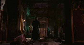 Movie still from “Black Sabbath” (1963), directed by Mario Bava – A man standing in front of a door in a dark room; Wide shot, Low angle