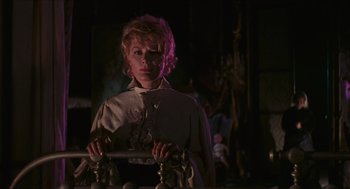 Movie still from “Black Sabbath” (1963), directed by Mario Bava – A woman standing in front of a mirror in a dark room; Medium shot, Low angle