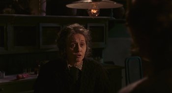 Movie still from “Black Sabbath” (1963), directed by Mario Bava – An older woman is talking to someone in a dark room; Close Up shot, Over the shoulder angle