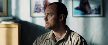 Movie still from “Black Sea” (2014), directed by Kevin Macdonald – A person wearing a shirt; Close Up shot, Low angle