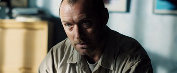 Movie still from “Black Sea” (2014), directed by Kevin Macdonald – A person wearing a shirt; Close Up shot, Low angle