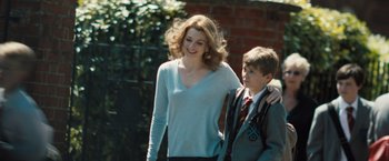 Movie still from “Black Sea” (2014), directed by Kevin Macdonald – A woman and a boy are walking together; Medium shot, Over the shoulder angle