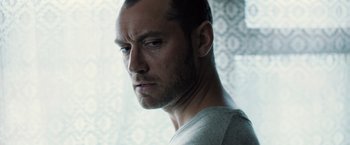 Movie still from “Black Sea” (2014), directed by Kevin Macdonald – A man's face in front of a window; Close Up shot, Low angle
