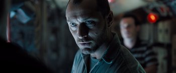 Movie still from “Black Sea” (2014), directed by Kevin Macdonald – A person wearing a green shirt; Close Up shot, Low angle