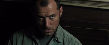 Movie still from “Black Sea” (2014), directed by Kevin Macdonald – A person staring at the camera; Close Up shot, Low angle