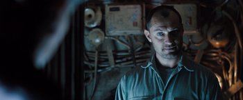 Movie still from “Black Sea” (2014), directed by Kevin Macdonald – A person in a room; Close Up shot, Low angle