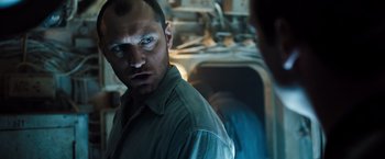 Movie still from “Black Sea” (2014), directed by Kevin Macdonald – A person in a room near a sink; Close Up shot, Low angle