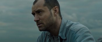 Movie still from “Black Sea” (2014), directed by Kevin Macdonald – A person wearing a shirt; Close Up shot, Low angle