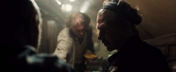 Movie still from “Black Sea” (2014), directed by Kevin Macdonald – A man with a beard is looking into the distance; Close Up shot, Over the shoulder angle