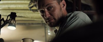 Movie still from “Black Sea” (2014), directed by Kevin Macdonald – A person wearing a shirt; Close Up shot, Low angle