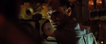 Movie still from “Black Sea” (2014), directed by Kevin Macdonald – A person looking at the camera; Close Up shot, Low angle