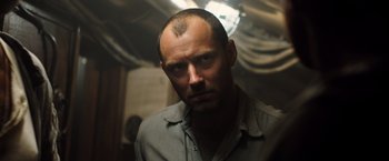 Movie still from “Black Sea” (2014), directed by Kevin Macdonald – A person with a shaved head; Close Up shot, Low angle