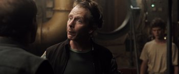 Movie still from “Black Sea” (2014), directed by Kevin Macdonald – A person wearing a jacket; Close Up shot, Over the shoulder angle