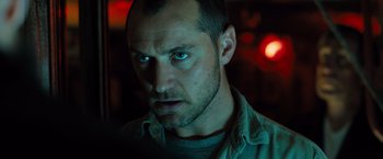 Movie still from “Black Sea” (2014), directed by Kevin Macdonald – A person staring at the camera; Close Up shot, Low angle
