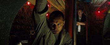 Movie still from “Black Sea” (2014), directed by Kevin Macdonald – A person with a hand up in the air; Close Up shot, Low angle