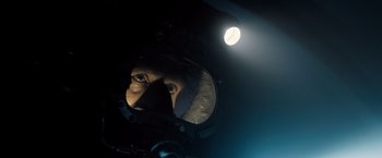 Movie still from “Black Sea” (2014), directed by Kevin Macdonald – A man is reflected in a mirror in a dark room; Close Up shot, Overhead angle