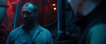 Movie still from “Black Sea” (2014), directed by Kevin Macdonald – A man standing in front of a light pole; Close Up shot, Over the shoulder angle