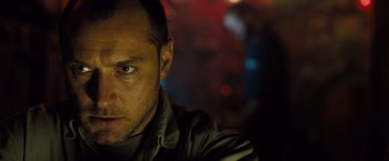 Movie still from “Black Sea” (2014), directed by Kevin Macdonald – A person wearing a green shirt; Close Up shot, Low angle
