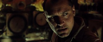 Movie still from “Black Sea” (2014), directed by Kevin Macdonald – A man's face in the dark; Close Up shot, Low angle