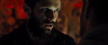 Movie still from “Black Sea” (2014), directed by Kevin Macdonald – A man with a long beard looking at the camera; Close Up shot, Low angle
